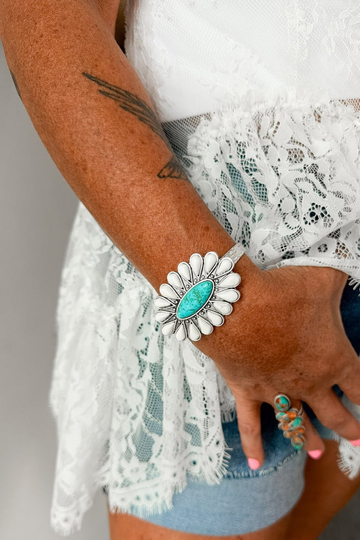Western turquoise statement cuff bracelet with ivory squash blossom-inspired details and antique silver finish, ideal for rodeo fashion, country concert outfits, Nashville style, and Southwestern jewelry collections.