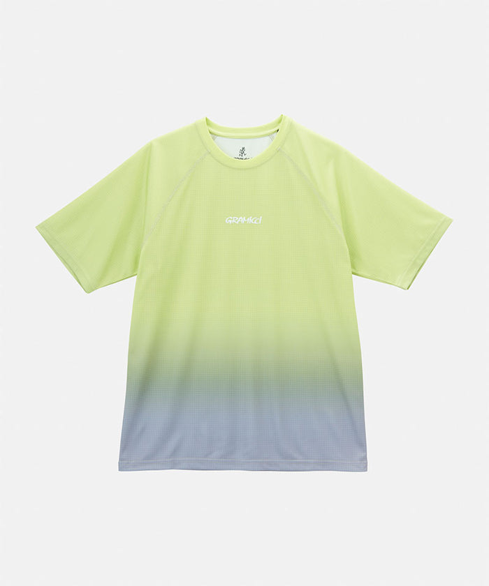 Gramicci yellow gradient UPF Shield S/S Top with a white Gramicci graphic against a light-tone background.