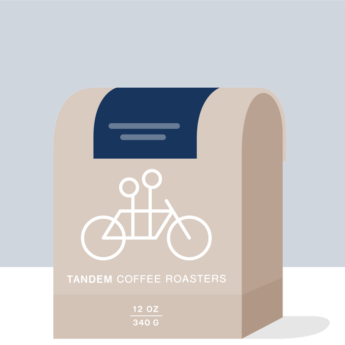 Uriel Cardona Colombia coffee bag with bicycle graphic on a beige bag