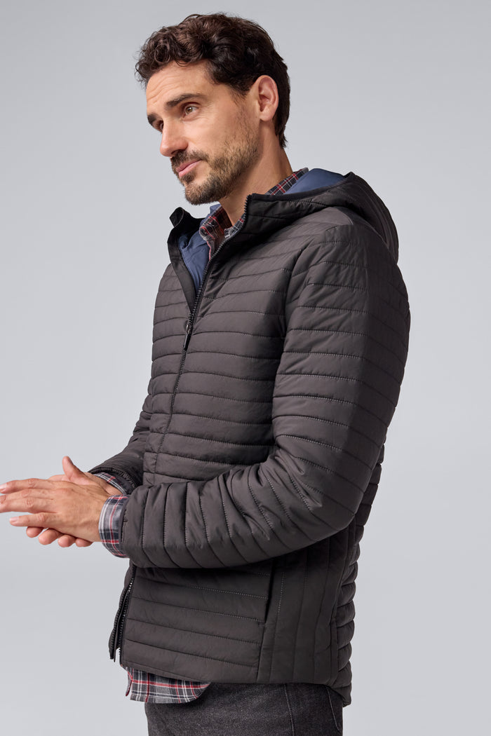 Side view of a man wearing Warmknit Air Jacket in True Black/Total Eclipse Liner