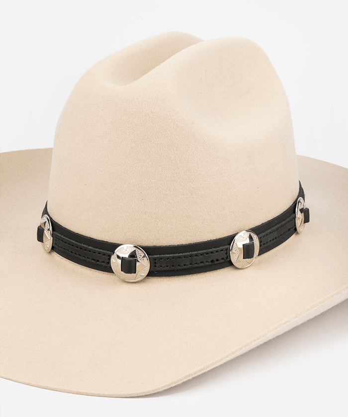 Beige cowboy hat with a black concho band featuring gold buttons on a white background #color_black