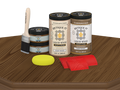 Retique It® Modern Walnut Wood Kit with primer, stain, brush, yellow sponge, and red graining tools on a wood tabletop.
