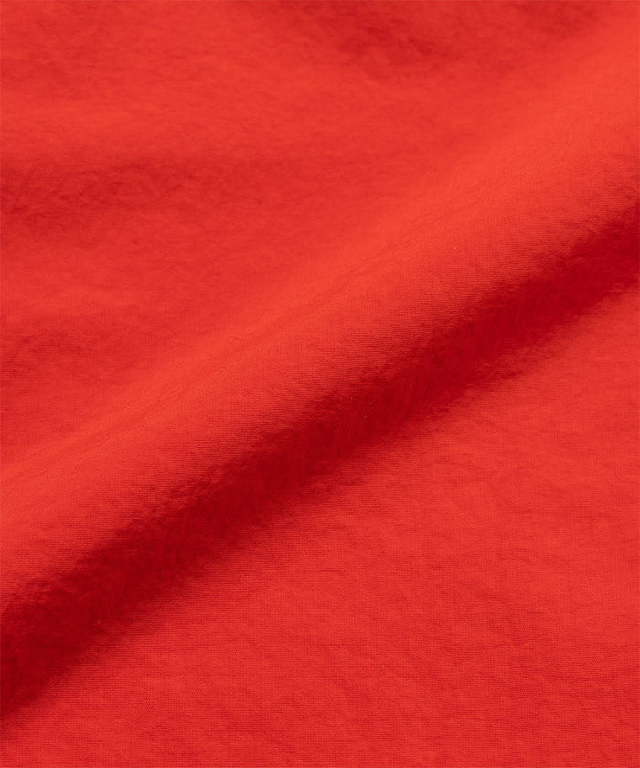 Burnt orange colored Gramicci Women's Nylon Active Short fabric swatch.