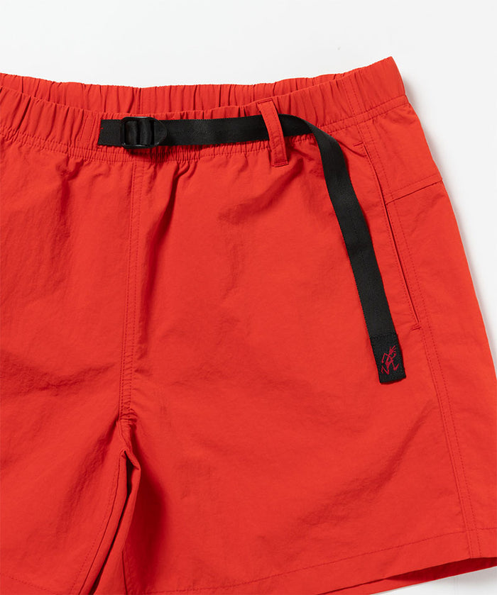 Close-up of Gramicci Women's Nylon Active Short in the color burnt orange against a light-tone background.