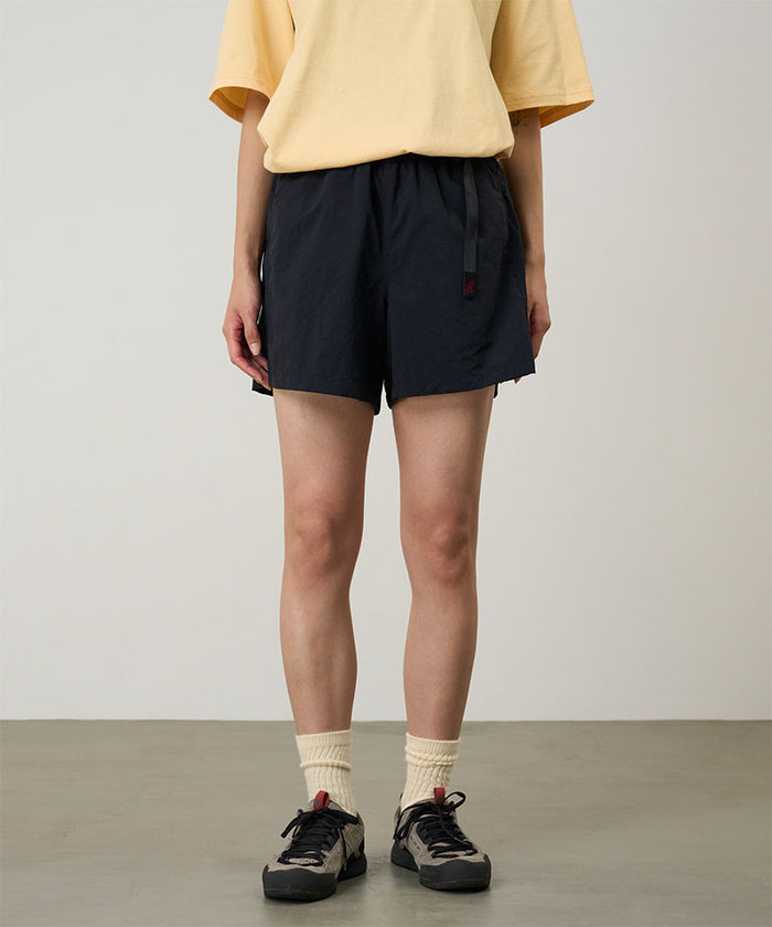 Model wearing black Gramicci Women's Nylon Active Short and a yellow shirt on a light-tone background.