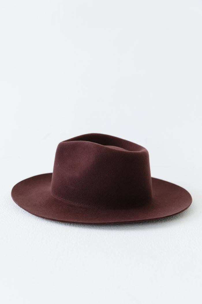 A dark cherry colored fedora hat on a white background #color_dark cherry