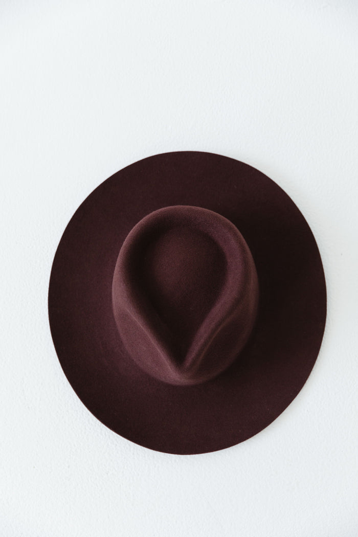 Picture of a dark cherry colored fedora hat clicked from the top on a white background #color_dark cherry